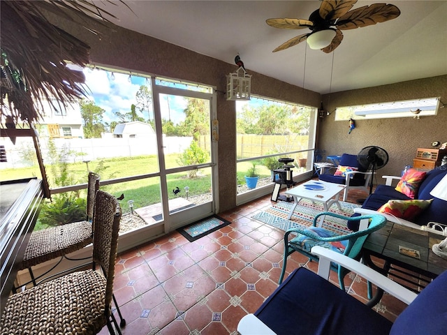 sunroom / solarium with a wealth of natural light, ceiling fan, and vaulted ceiling