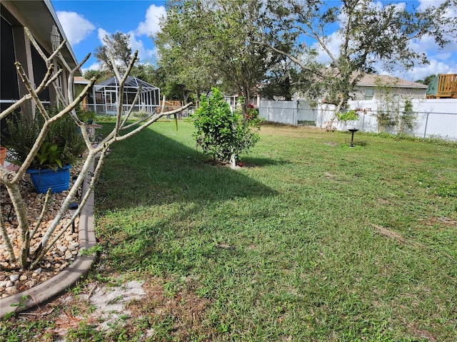 view of yard featuring glass enclosure