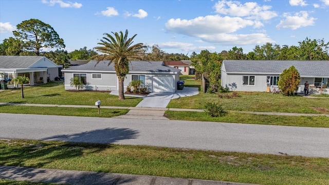 single story home with a front yard and a garage