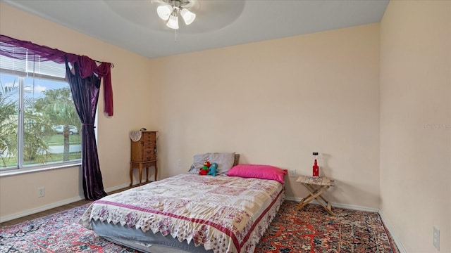 bedroom featuring multiple windows and ceiling fan