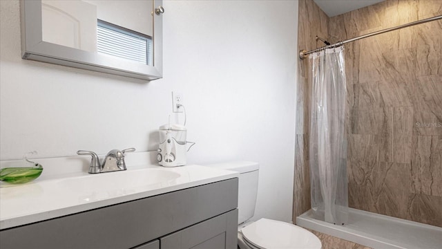 bathroom featuring vanity, toilet, and walk in shower