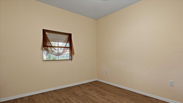 spare room with hardwood / wood-style flooring