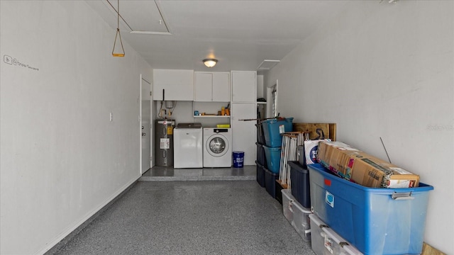 garage with washer and clothes dryer and water heater