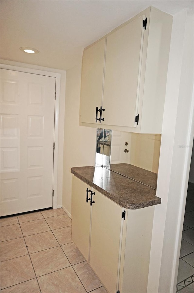 kitchen with white cabinetry and light tile patterned flooring