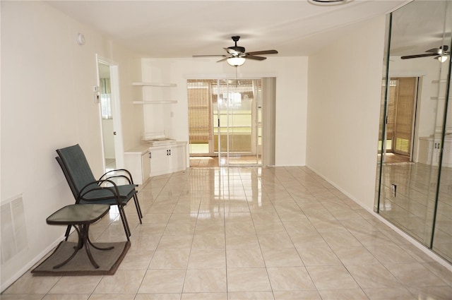 sitting room featuring light tile patterned floors and ceiling fan