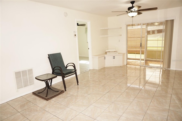 unfurnished room with ceiling fan and light tile patterned floors