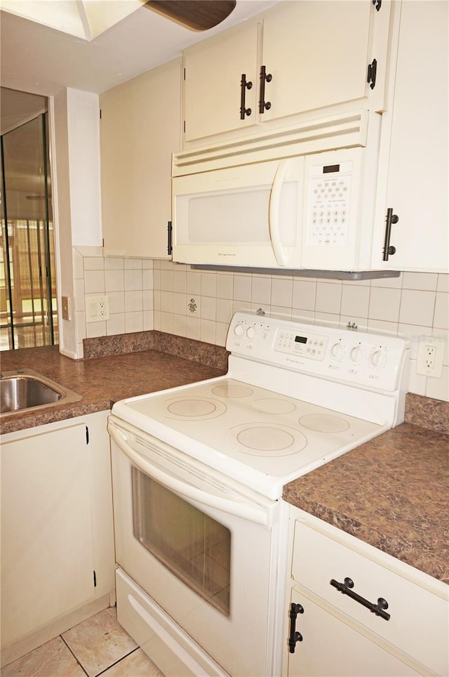 kitchen with light tile patterned floors, white appliances, backsplash, and sink