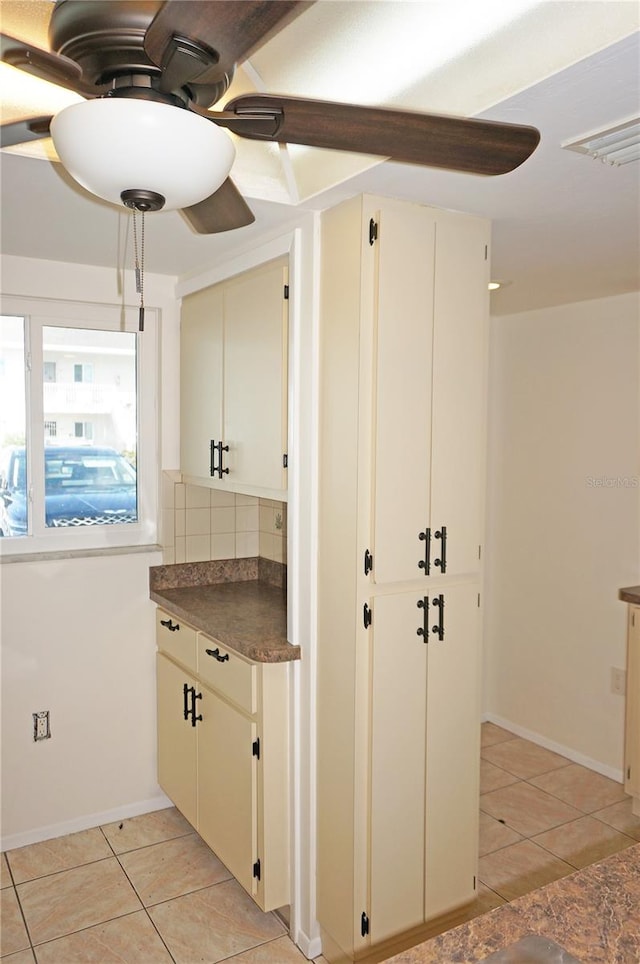 kitchen featuring decorative backsplash and light tile patterned floors