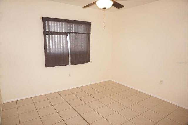 tiled empty room featuring ceiling fan