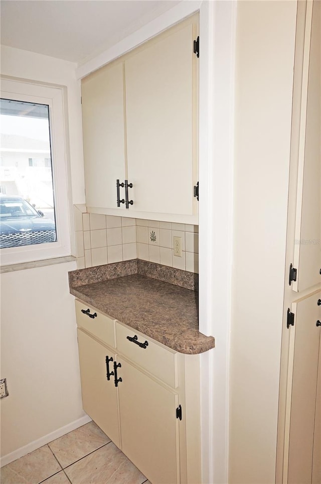 kitchen with light tile patterned floors and backsplash