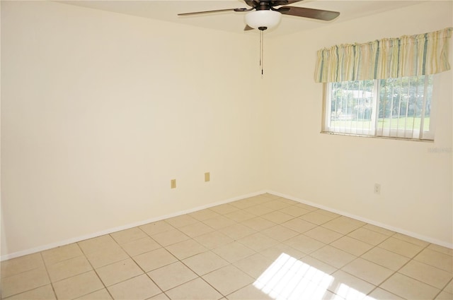 spare room with light tile patterned flooring and ceiling fan