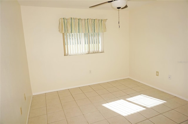 spare room with ceiling fan and light tile patterned floors