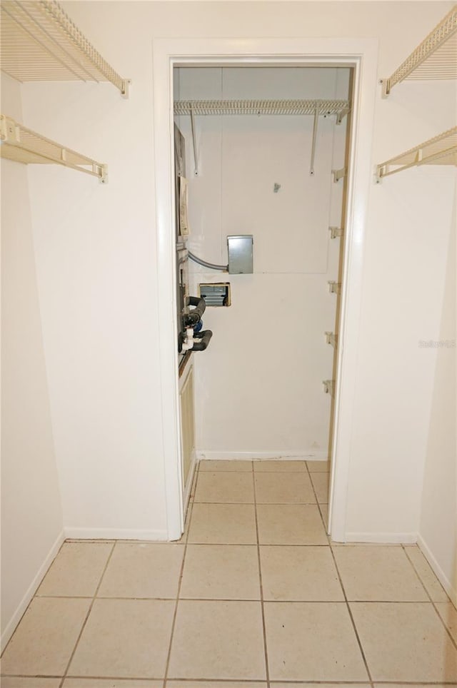 corridor featuring light tile patterned floors