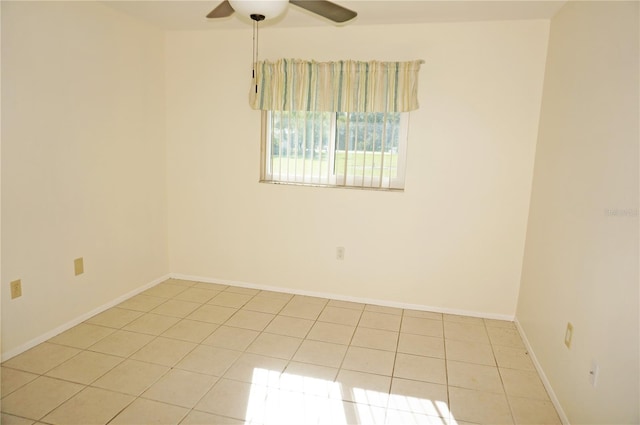 tiled spare room with ceiling fan