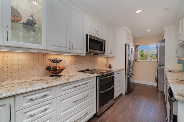 kitchen featuring stainless steel appliances, light stone counters, dark hardwood / wood-style flooring, backsplash, and white cabinets