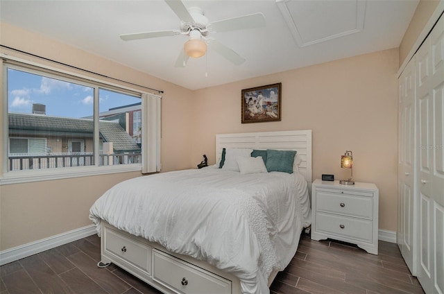 bedroom with ceiling fan, dark wood-type flooring, and a closet