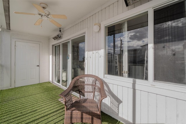 sunroom / solarium featuring ceiling fan