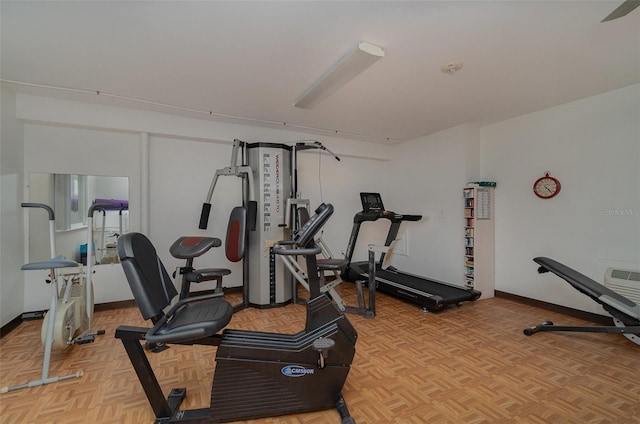 exercise area featuring light parquet flooring