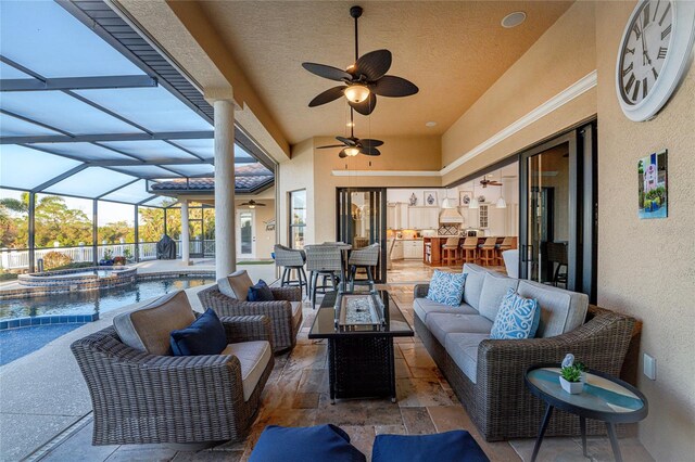 view of patio / terrace with an outdoor hangout area, glass enclosure, ceiling fan, and a pool with hot tub