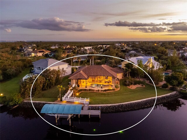 aerial view at dusk with a water view