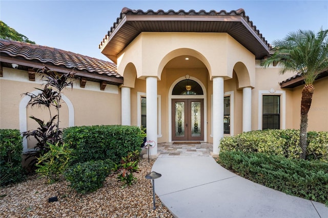 view of exterior entry featuring french doors