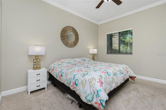 bedroom with ceiling fan, light colored carpet, and ornamental molding