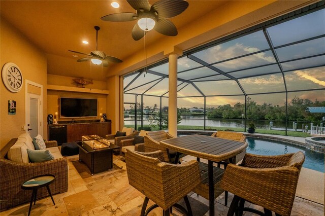 view of patio / terrace with an outdoor hangout area, glass enclosure, and ceiling fan