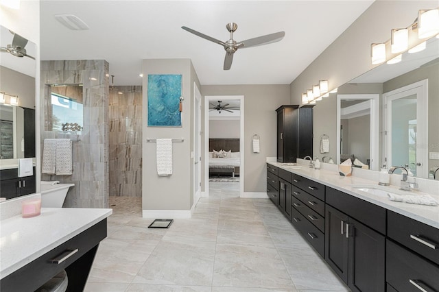 bathroom with vanity and a tile shower