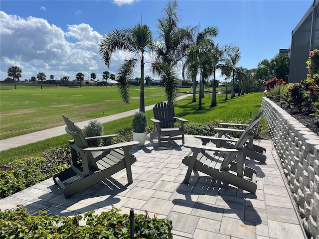 surrounding community with a patio and a yard