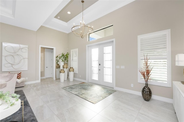 entryway featuring an inviting chandelier and french doors