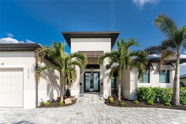 view of front of home with french doors and a garage