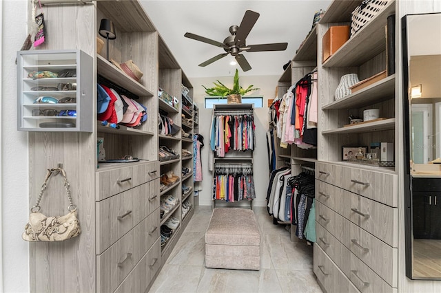 spacious closet featuring ceiling fan and light tile patterned flooring