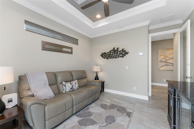 tiled living room with ceiling fan, crown molding, and a tray ceiling