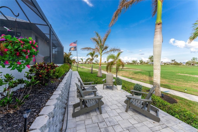 view of patio featuring glass enclosure