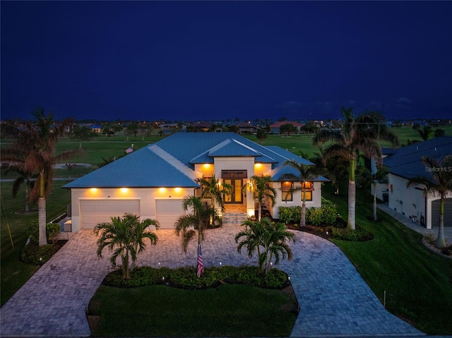 view of front of house featuring a garage and a yard