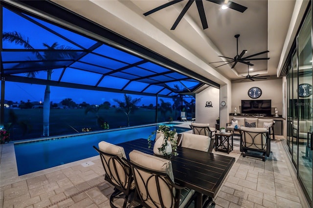 patio terrace at dusk with glass enclosure and ceiling fan