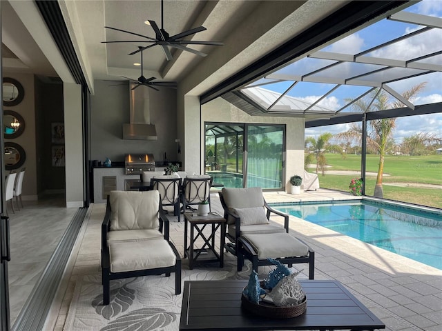 view of pool with ceiling fan, area for grilling, a lanai, and a patio area