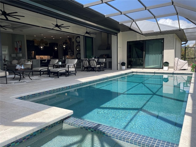 view of pool featuring an in ground hot tub, ceiling fan, glass enclosure, and a patio area