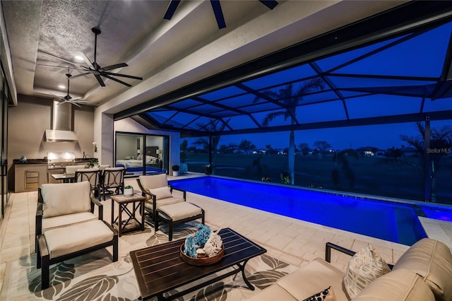 pool at twilight with ceiling fan and a grill