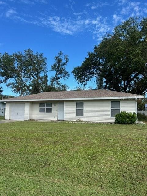 single story home with a garage and a front lawn