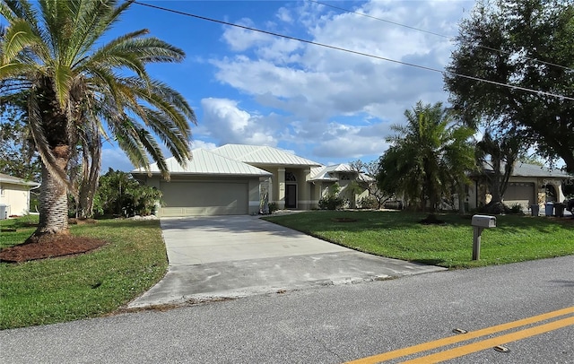 view of front of property with a garage and a front lawn