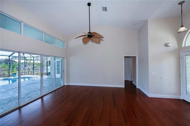 unfurnished living room with dark hardwood / wood-style flooring, high vaulted ceiling, and ceiling fan