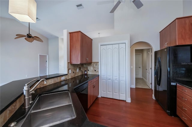 kitchen with dark hardwood / wood-style flooring, backsplash, ceiling fan, sink, and black appliances