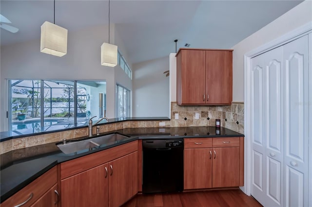 kitchen with sink, black dishwasher, tasteful backsplash, dark hardwood / wood-style flooring, and pendant lighting