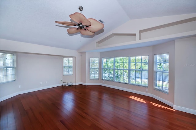 empty room with hardwood / wood-style flooring, ceiling fan, and lofted ceiling