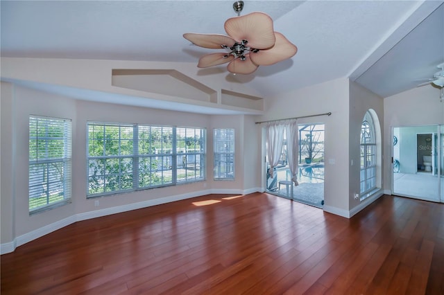 interior space with dark hardwood / wood-style floors, ceiling fan, and lofted ceiling