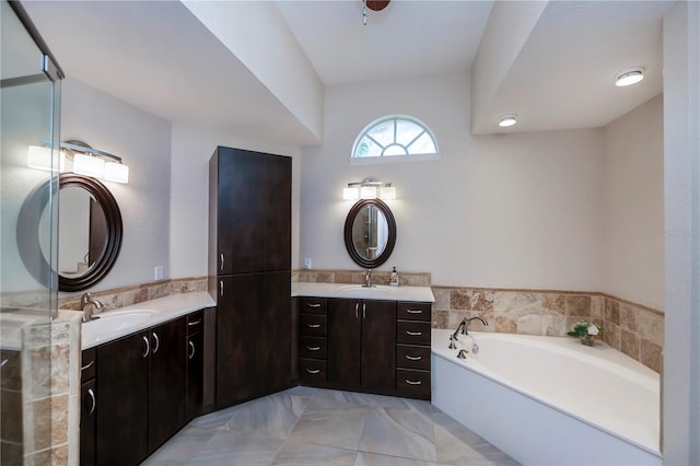 bathroom featuring a tub to relax in and vanity