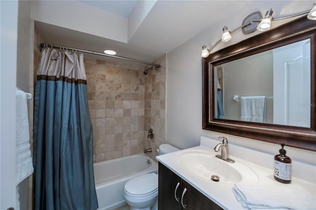 full bathroom with vanity, shower / tub combo, and toilet