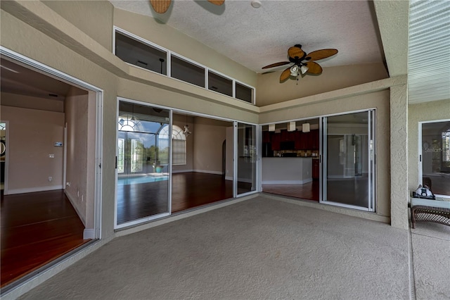 unfurnished sunroom with ceiling fan and lofted ceiling