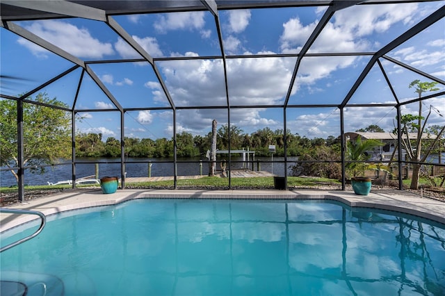 view of pool with a lanai and a water view